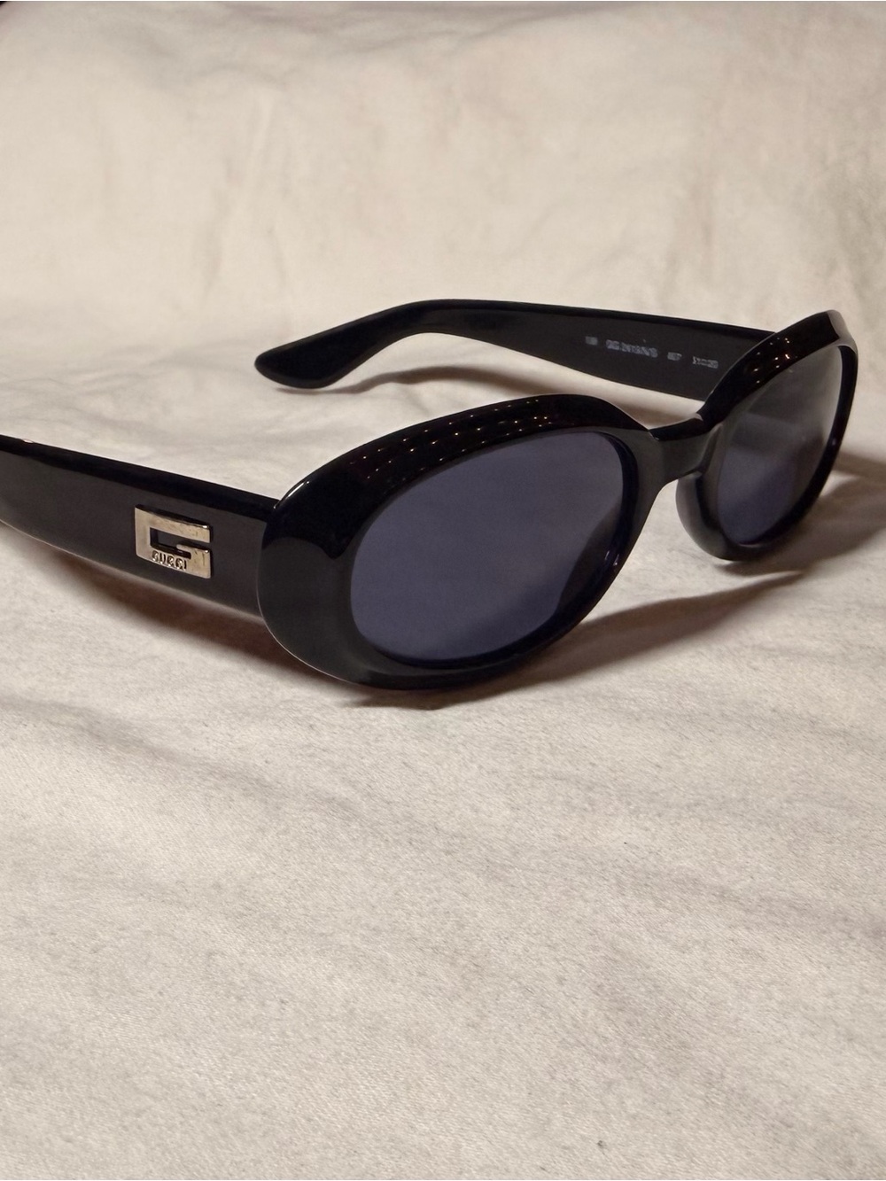 Gucci Black Oval Sunglasses with Silver Logo Accent